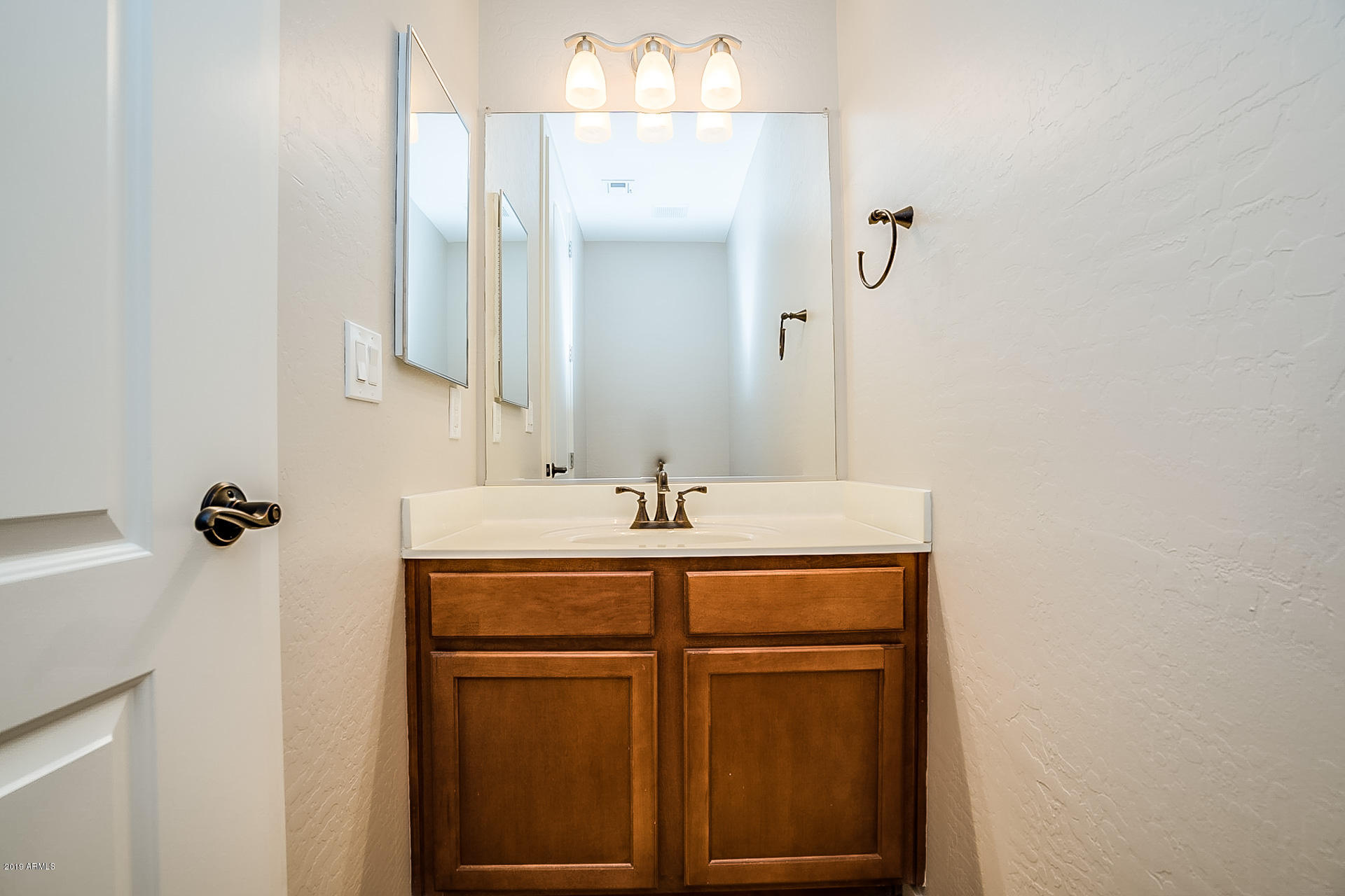 4746 East Culver Street Phoenix, AZ 85008 - Photo 12 of 13 a bathroom with a sink and a mirror