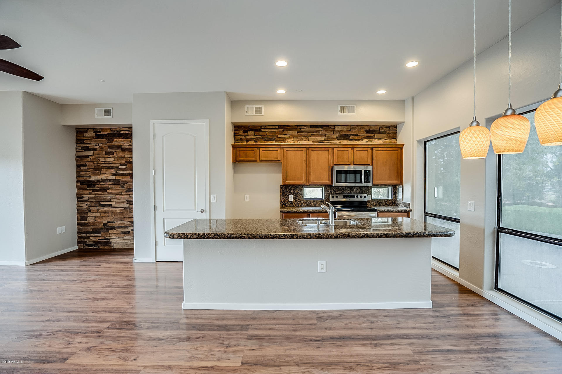 4746 East Culver Street Phoenix, AZ 85008 - Photo 2 of 13 a kitchen with stainless steel appliances granite countertop a sink and a stove