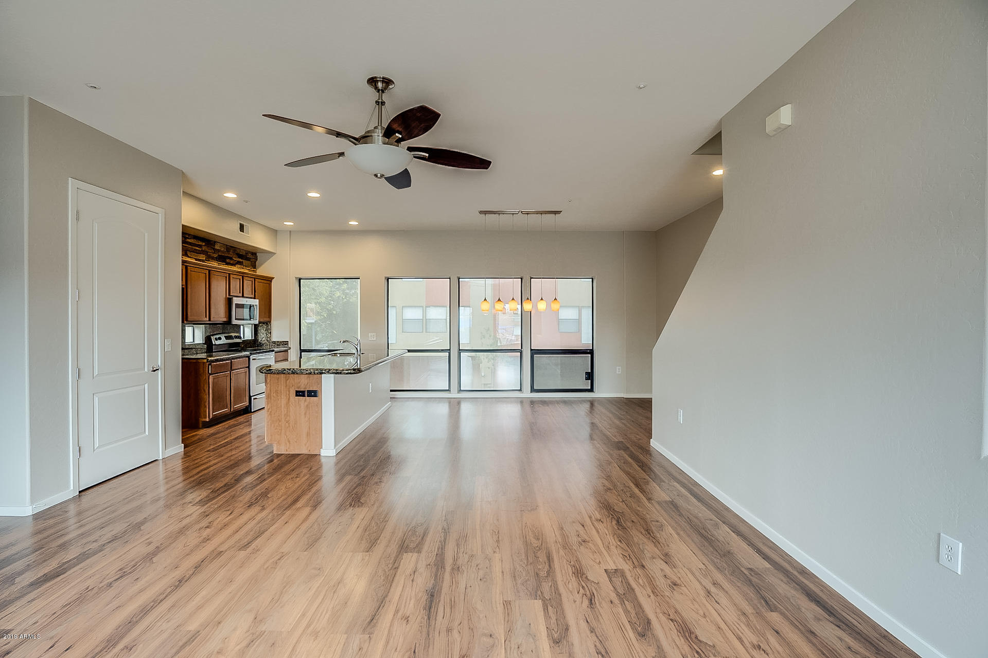 4746 East Culver Street Phoenix, AZ 85008 - Photo 3 of 13 a view of an empty room with wooden floor and a window