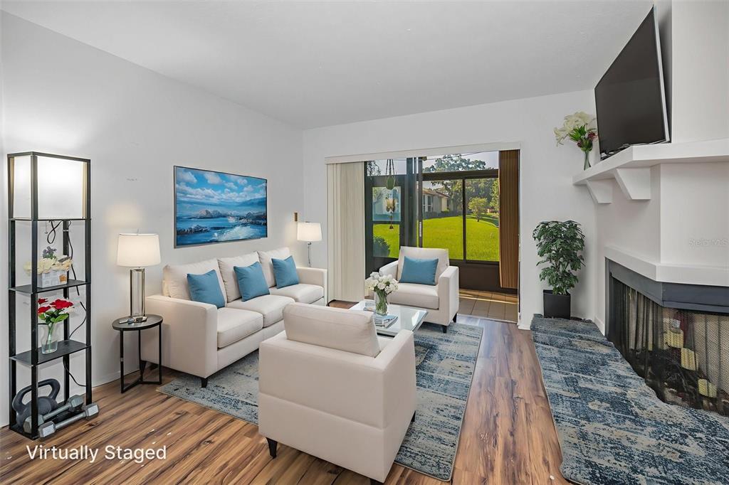103 Lakeview Place, Unit 3 Oldsmar, FL 34677 - Photo 15 of 54 a living room with furniture fireplace and flat screen tv