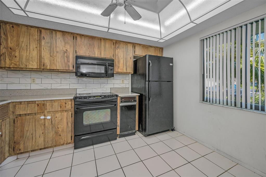 103 Lakeview Place, Unit 3 Oldsmar, FL 34677 - Photo 20 of 54 a kitchen with stainless steel appliances granite countertop a refrigerator a stove a sink and a microwave