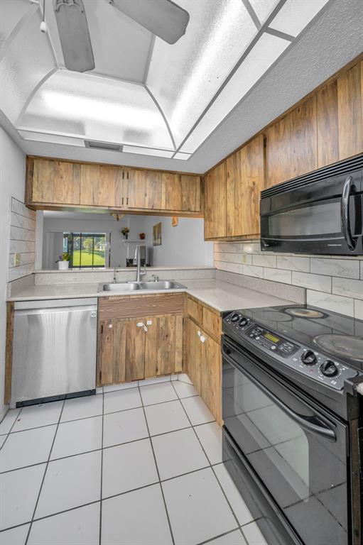 103 Lakeview Place, Unit 3 Oldsmar, FL 34677 - Photo 22 of 54 a kitchen with a stove a sink a microwave and cabinets