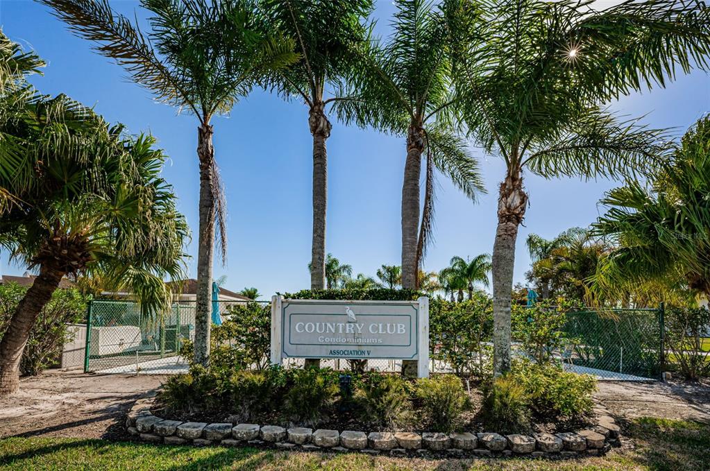 103 Lakeview Place, Unit 3 Oldsmar, FL 34677 - Photo 43 of 54 a sign board with flower garden and palm trees
