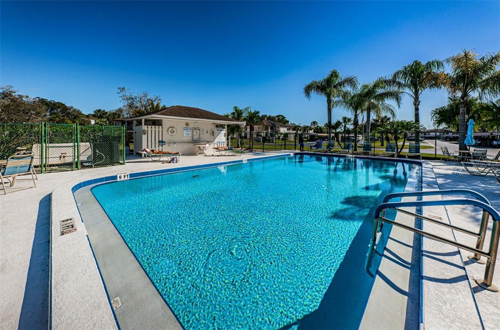 103 Lakeview Place, Unit 3 Oldsmar, FL 34677 - Photo 51 of 54 a view of a swimming pool with a table and chairs