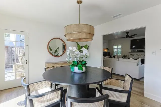 a living room with furniture and a potted plant