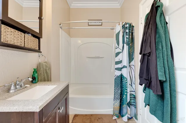 a bathroom with a sink a mirror and a shower