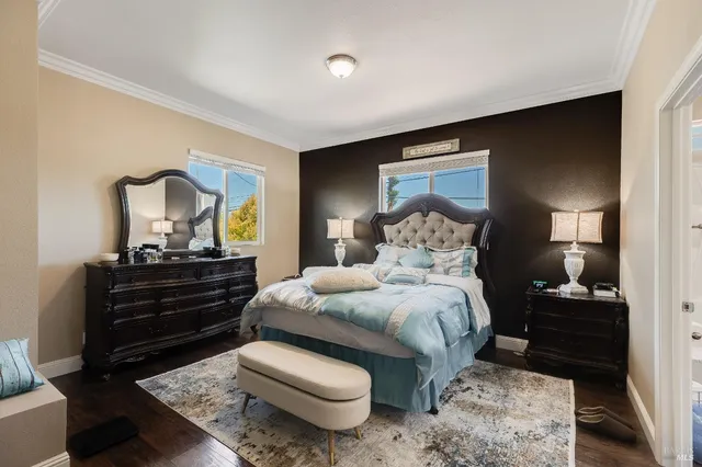 a bed room with a bed and a lamp on dresser