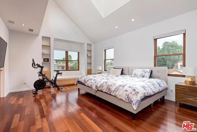 a bedroom with a bed and a large window