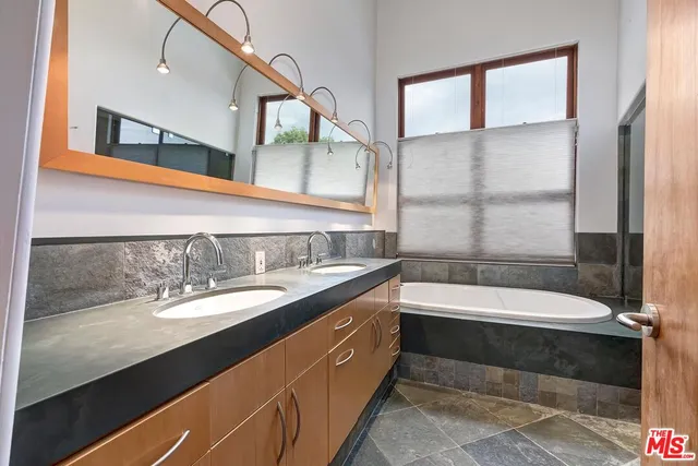 a bathroom with a bathtub and a sink