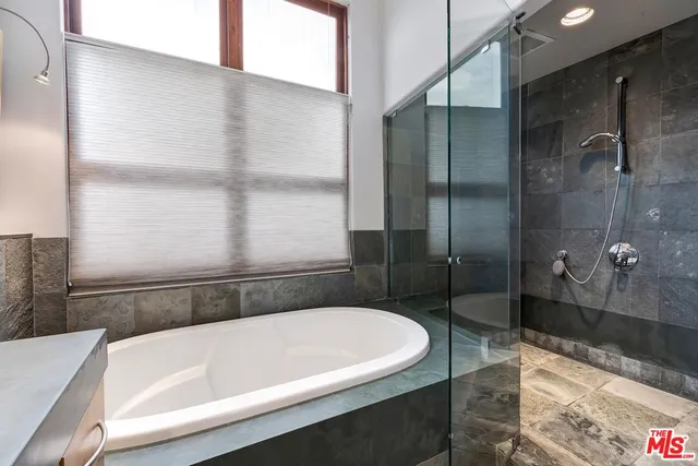 a bathroom with a bathtub and a shower
