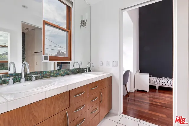a bathroom with a double vanity sink and a mirror