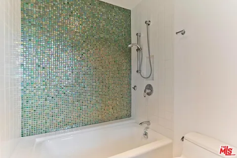 a bathroom with a bathtub and shower