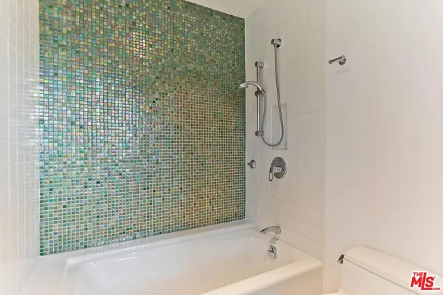 a bathroom with a bathtub and shower