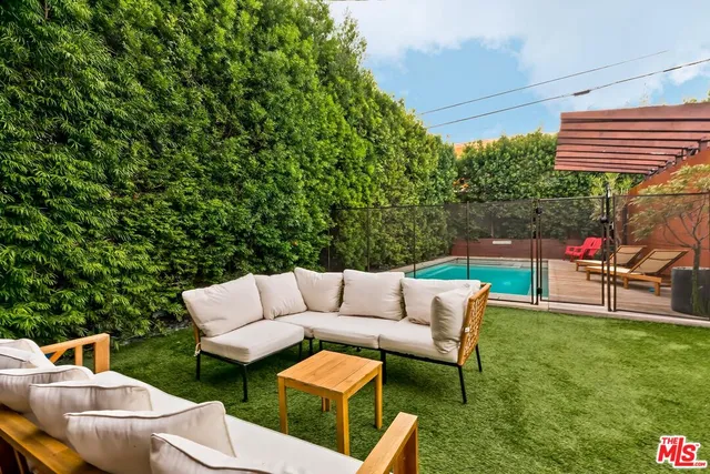a backyard of a house with table and chairs