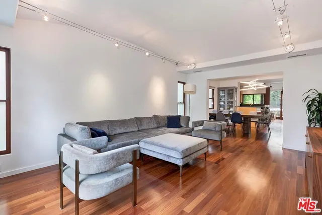 a living room with fireplace furniture and wooden floor