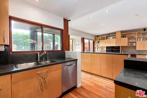 a kitchen with stainless steel appliances granite countertop a sink and a microwave