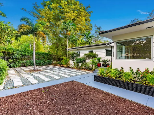 a view of a garden with flowers and plants