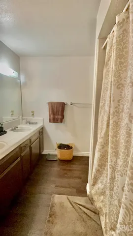 a bathroom with a double vanity sink and mirror