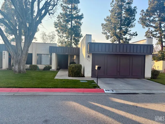 a view of a house with a yard and tree s