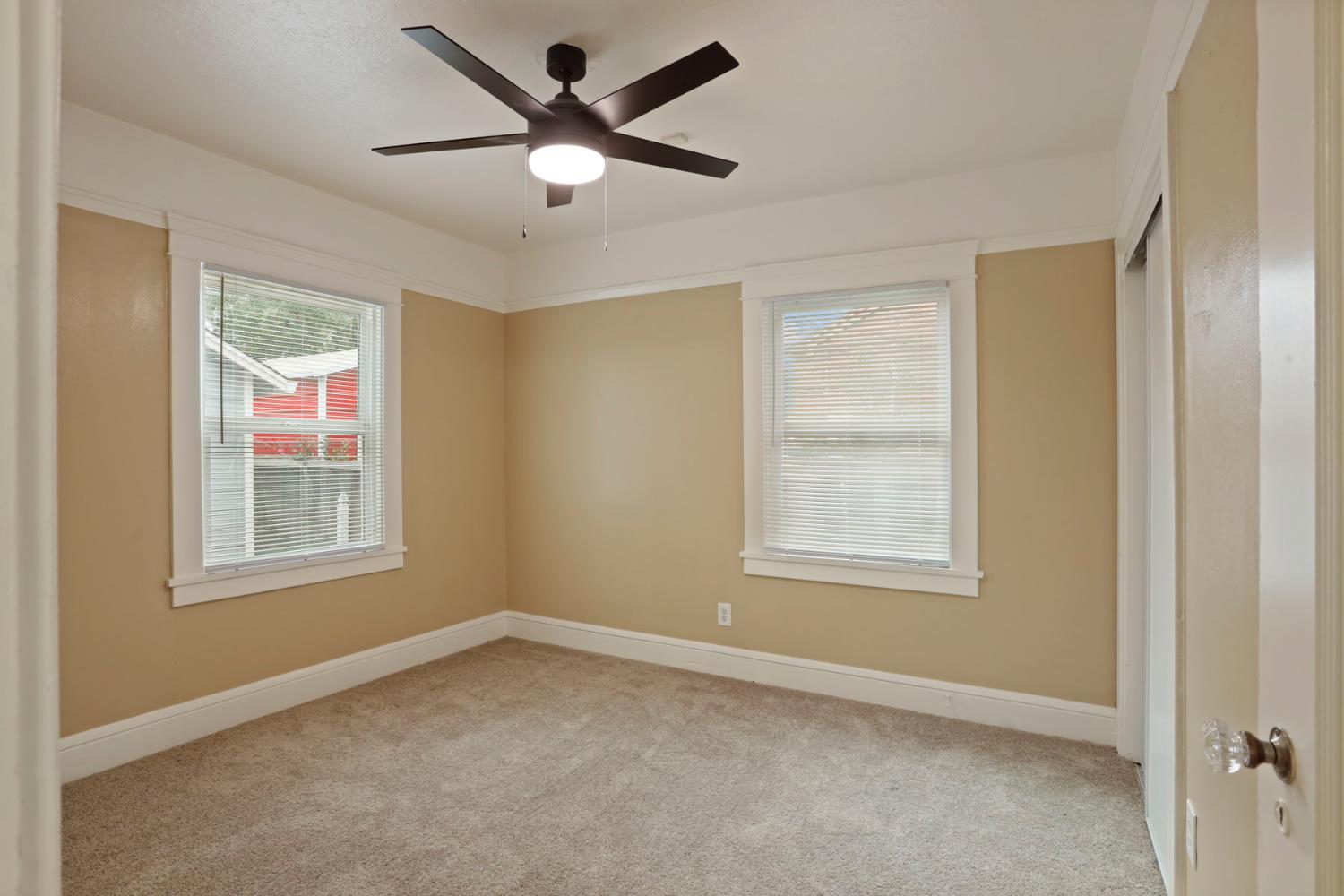 116 East Noble Street Stockton, CA 95204 - Photo 16 of 27 Second bedroom with new carpet, interior paint, ceiling fan, blinds on the windows. Another glass door knob, sorry...I love the classic touches on this home!