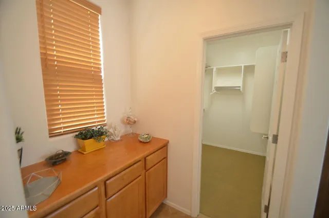 a bathroom with a sink mirror and shower