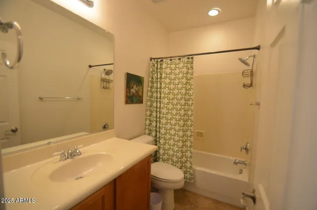 a large white bed in a bedroom next to a window