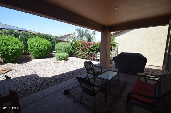 a view of a chairs and table in the patio