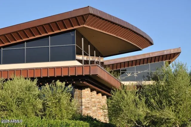 a living room with furniture a window and bookshelf