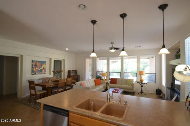a living room with furniture and kitchen view
