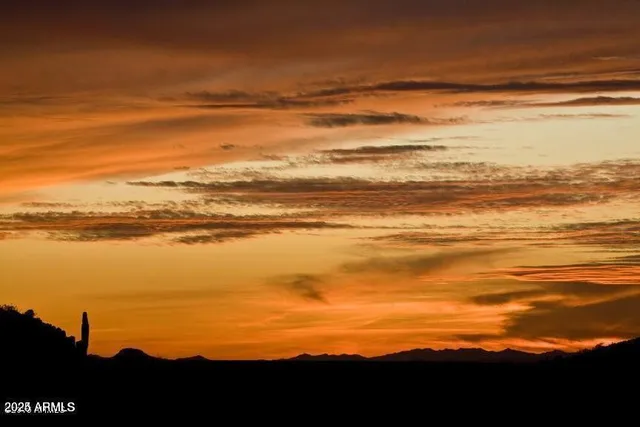 a kitchen with lots of wooden furniture appliances and dining table