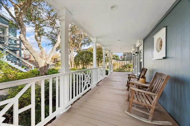 a view of two chairs in balcony with wooden floor