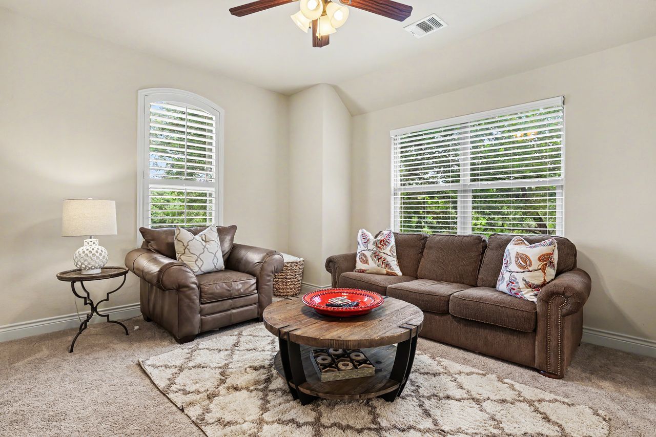 809 Prairie Dunes Drive Georgetown, TX 78628 - Photo 22 of 40 Natural light filters through the windows, illuminating this cozy living space with a ceiling fan.