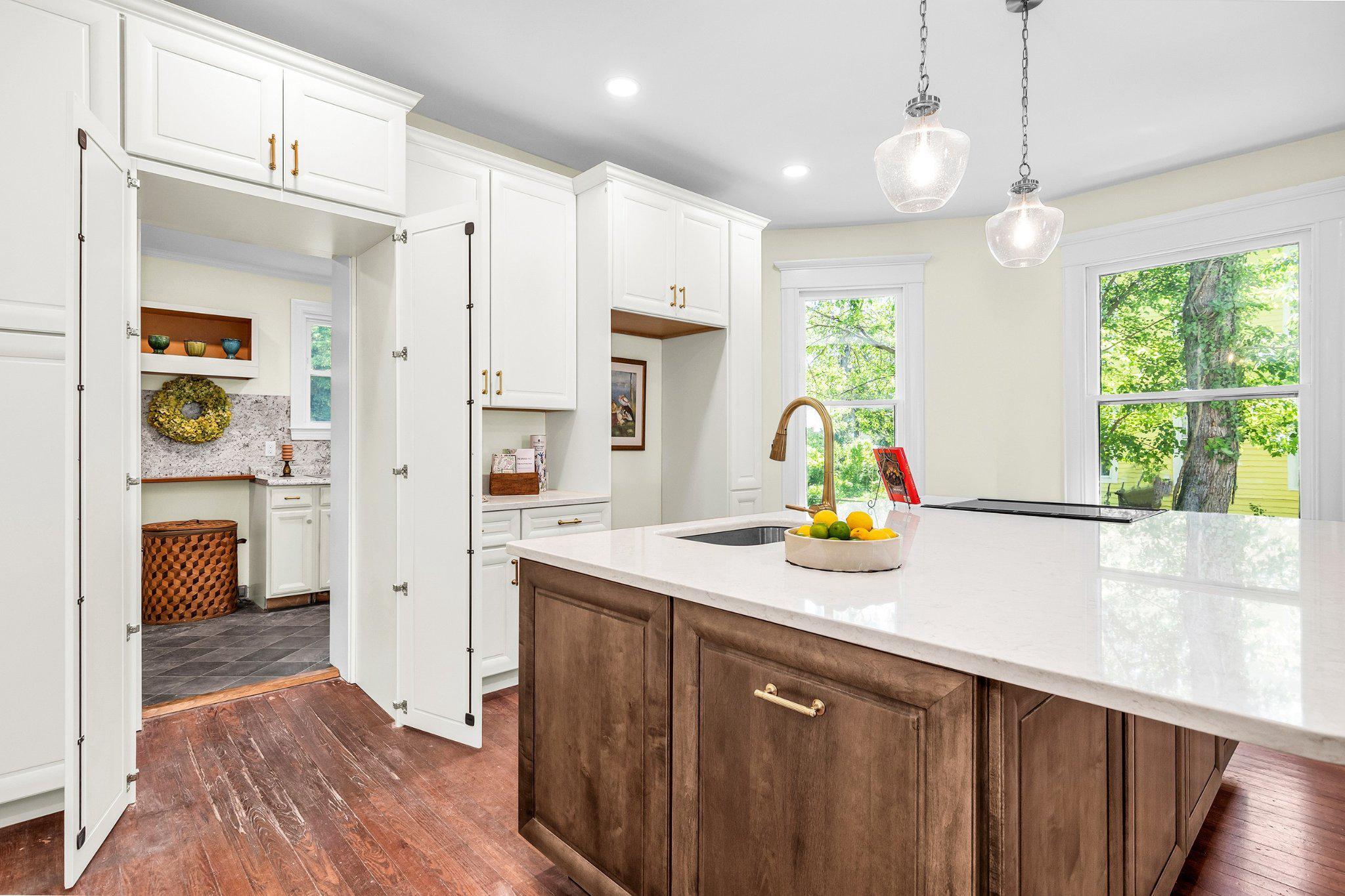 709 Church Street Cambridge, MD 21613 - Photo 15 of 36 a kitchen with kitchen island white cabinets and refrigerator