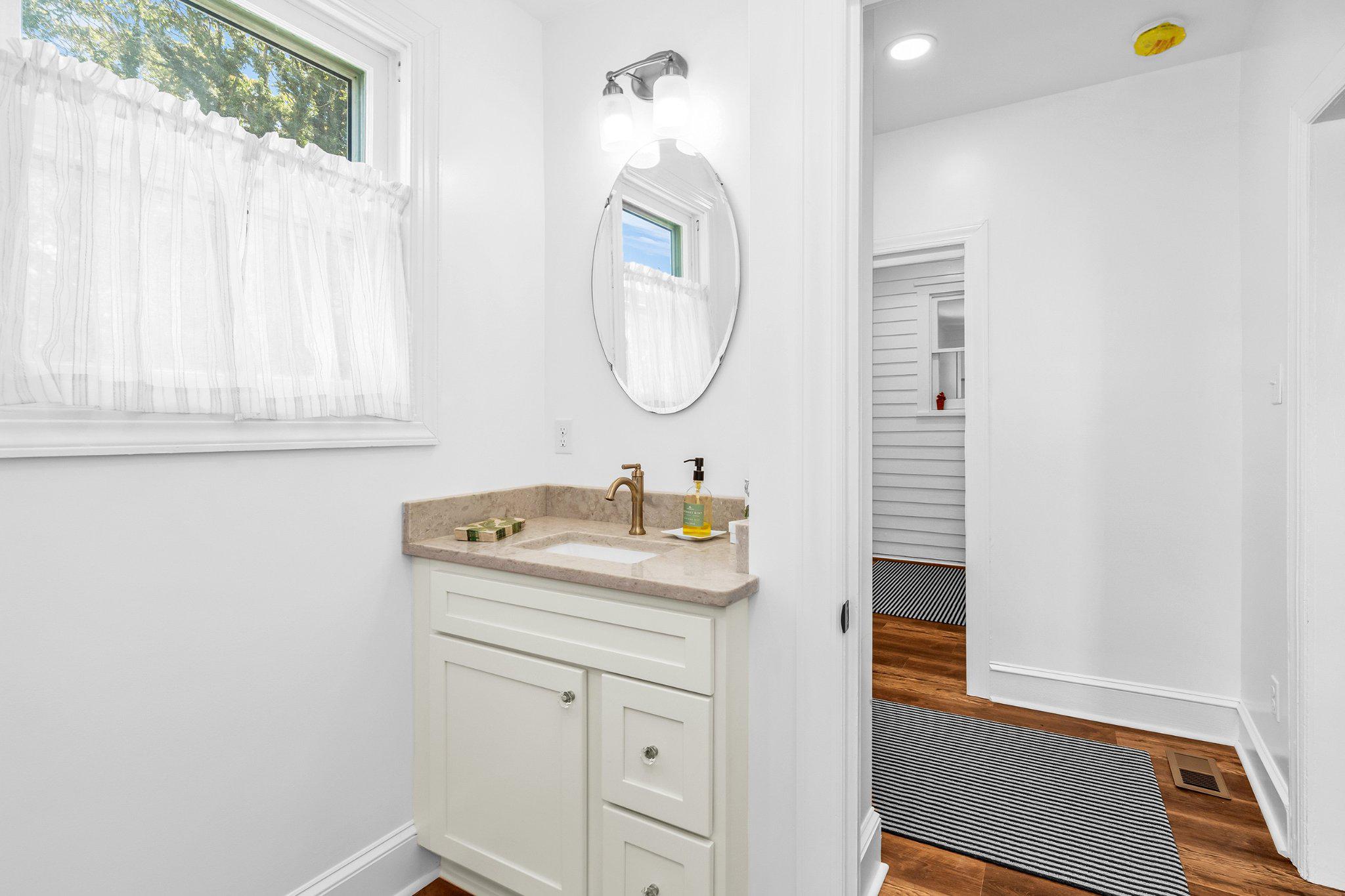709 Church Street Cambridge, MD 21613 - Photo 25 of 36 a bathroom with a sink and a mirror