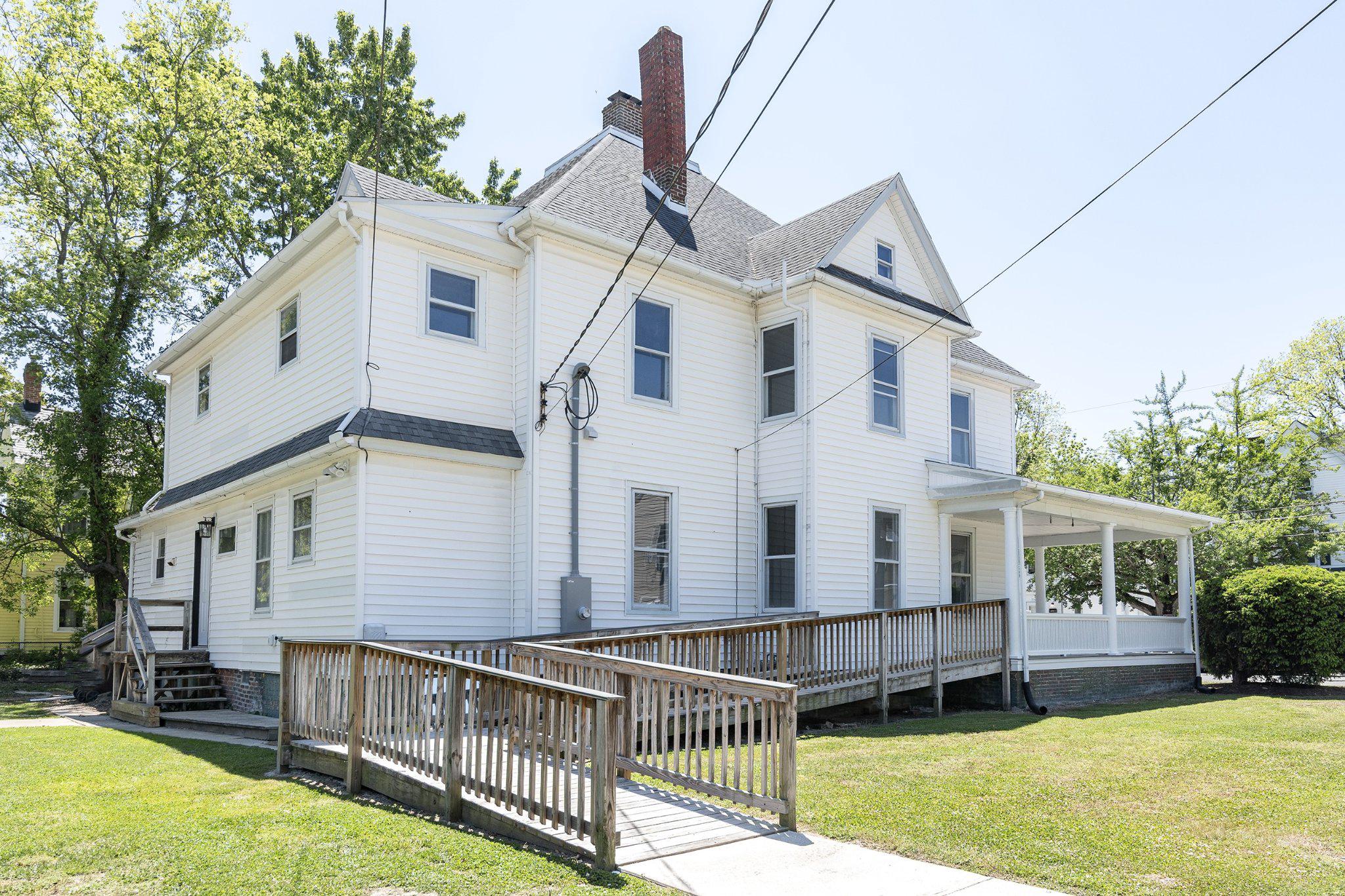 709 Church Street Cambridge, MD 21613 - Photo 29 of 36 a view of a house with wooden deck and a yard