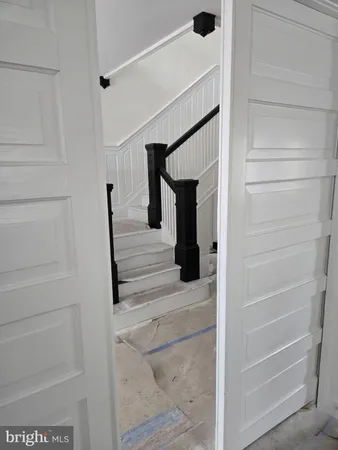 a view of staircase with white walls and railing