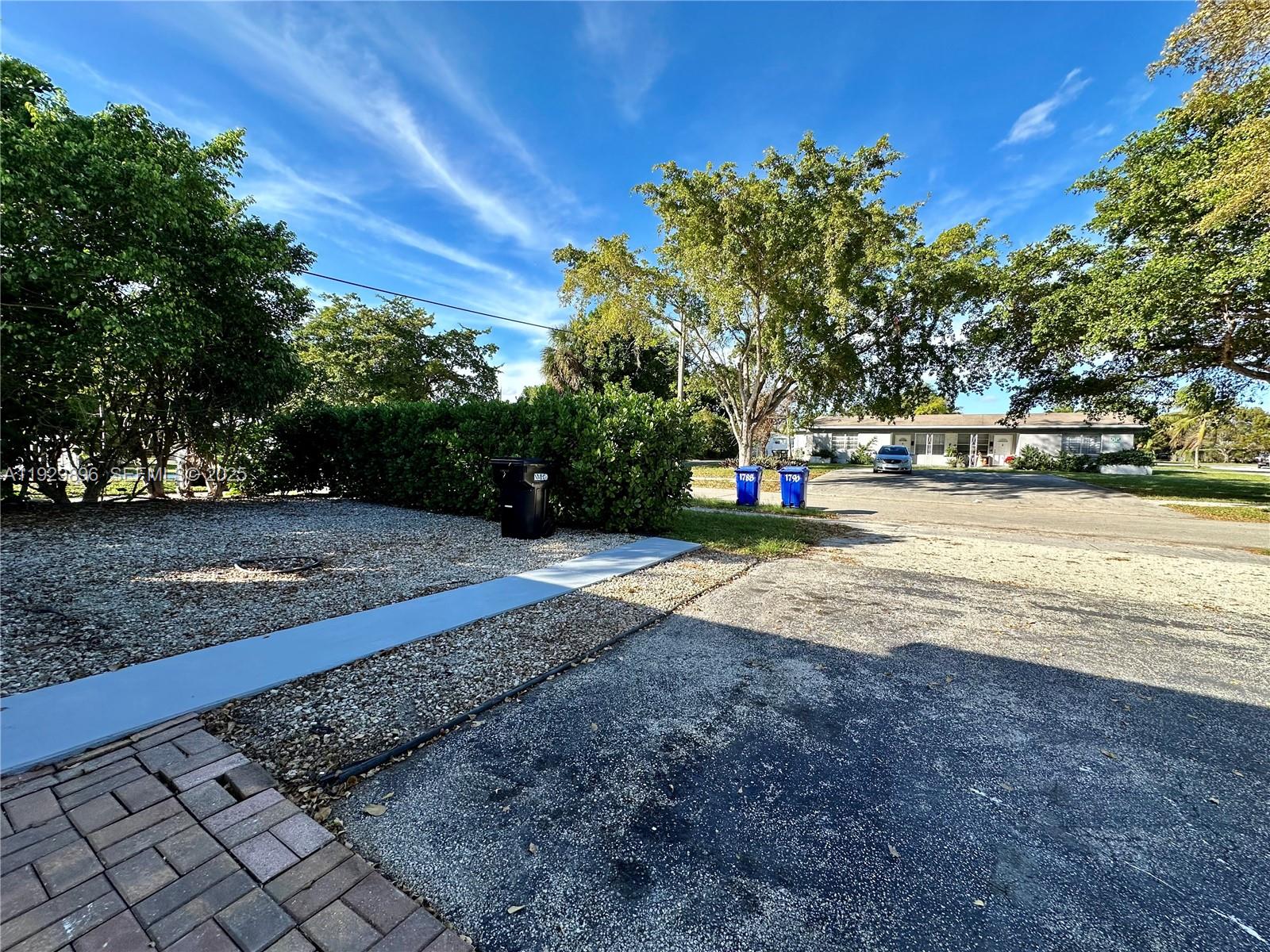 1788 Northeast 169th Street, Unit 1 North Miami Beach, FL 33162 - Photo 19 of 19 a view of street with trees