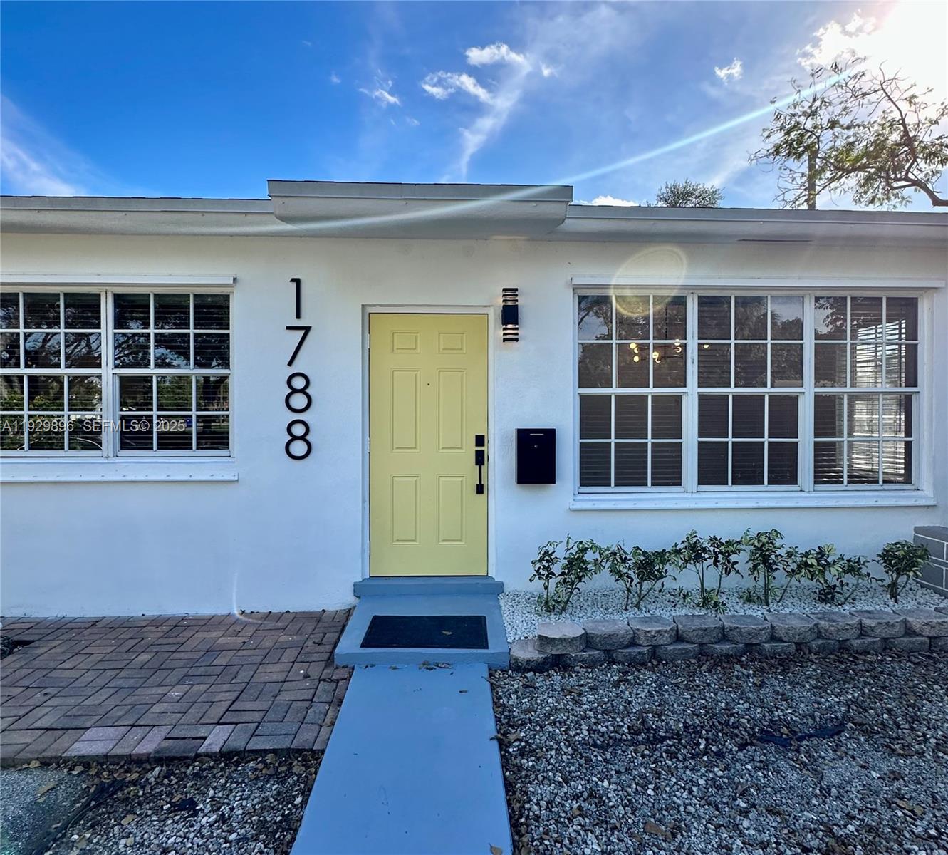 1788 Northeast 169th Street, Unit 1 North Miami Beach, FL 33162 - Photo 2 of 19 a front view of a house with a yard