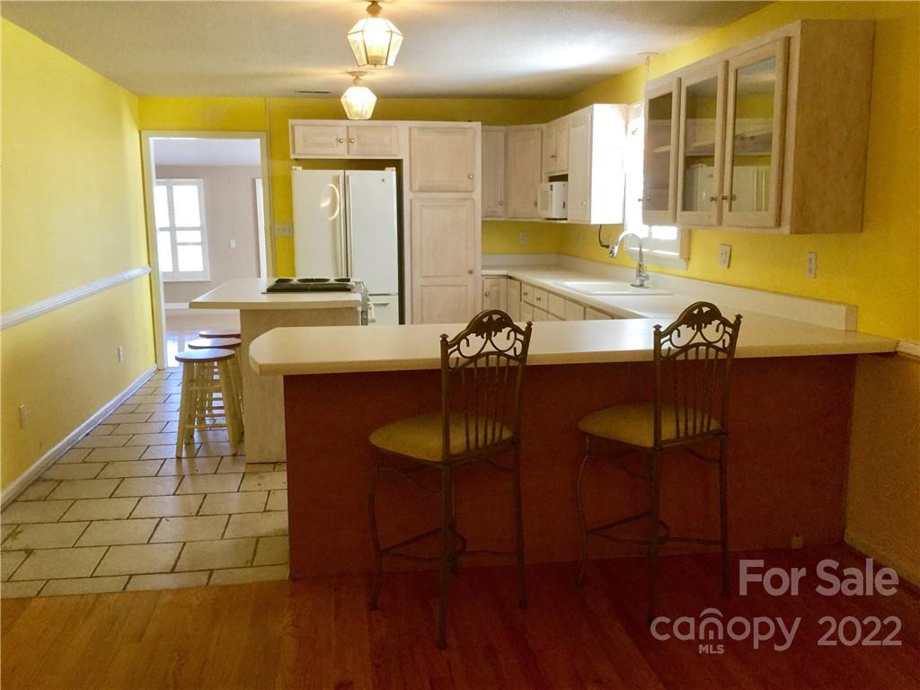 3371 Flat Creek Road Lancaster, SC 29720 - Photo 14 of 38 a view of a dining room with furniture and wooden floor