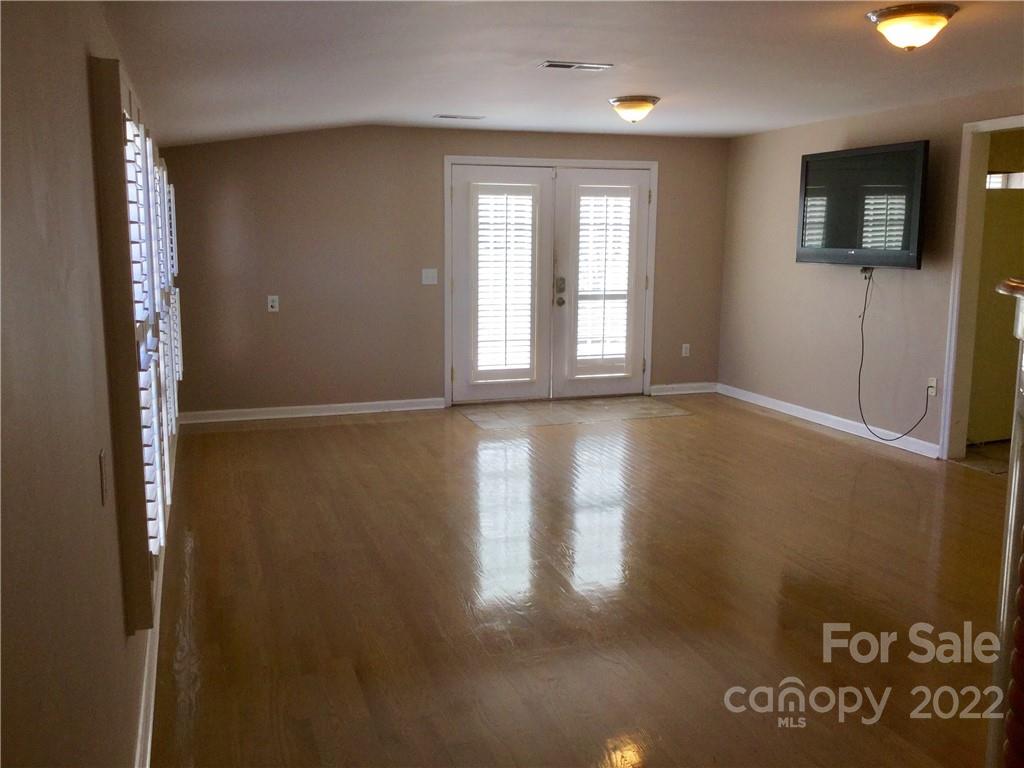 3371 Flat Creek Road Lancaster, SC 29720 - Photo 19 of 38 a view of an empty room with wooden floor and a window
