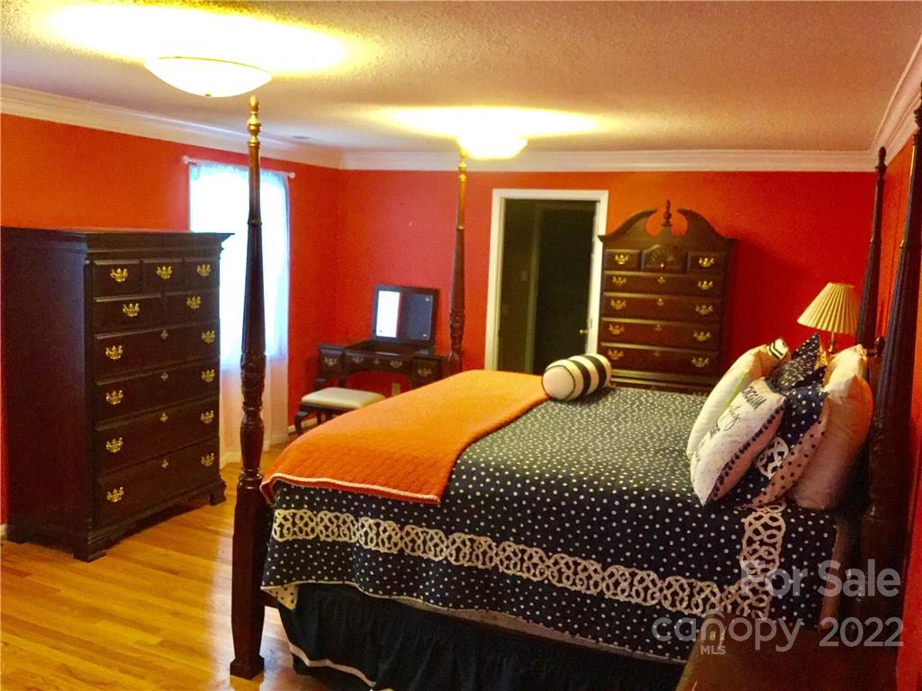 3371 Flat Creek Road Lancaster, SC 29720 - Photo 21 of 38 a bedroom with a bed a closet and lamp
