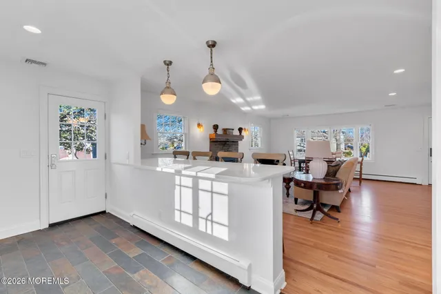 a living room with kitchen island furniture and a wooden floor