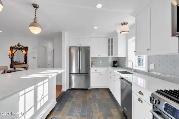 a kitchen with a sink stove and refrigerator