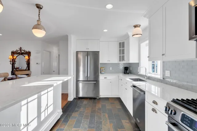 a kitchen with a sink stove and refrigerator