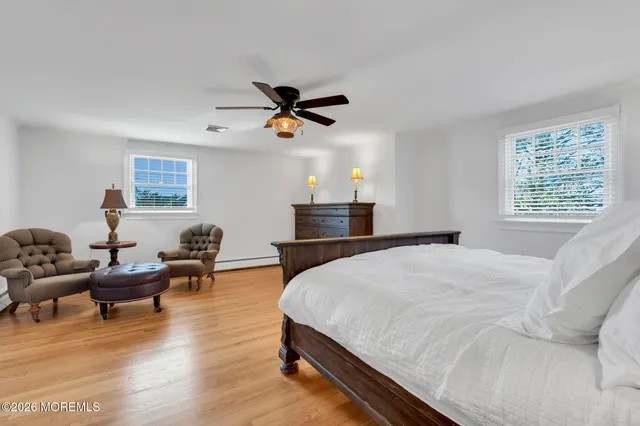 a bedroom with furniture and a large window