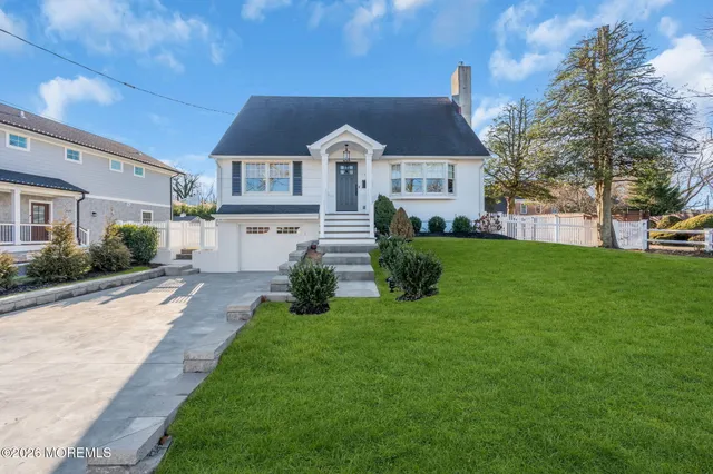 a front view of house with yard and green space