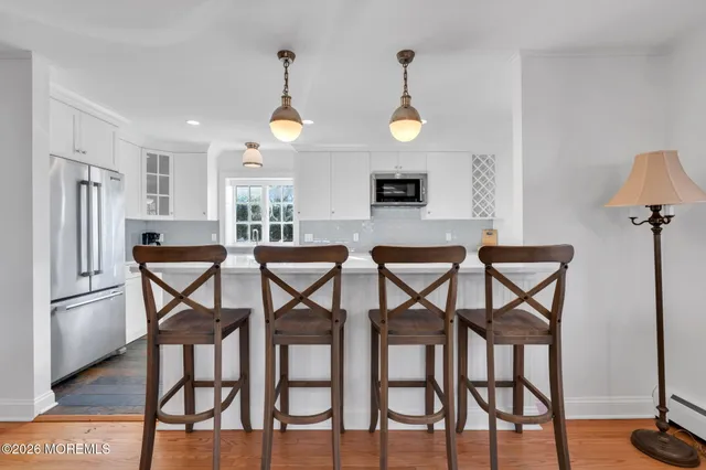 a view of a dining room with furniture and a chandelier