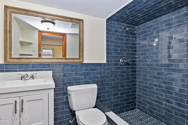 a bathroom with a toilet sink and mirror