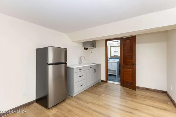 a kitchen with a refrigerator sink and cabinets