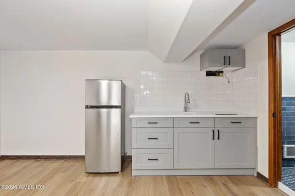 a kitchen with a refrigerator and cabinets